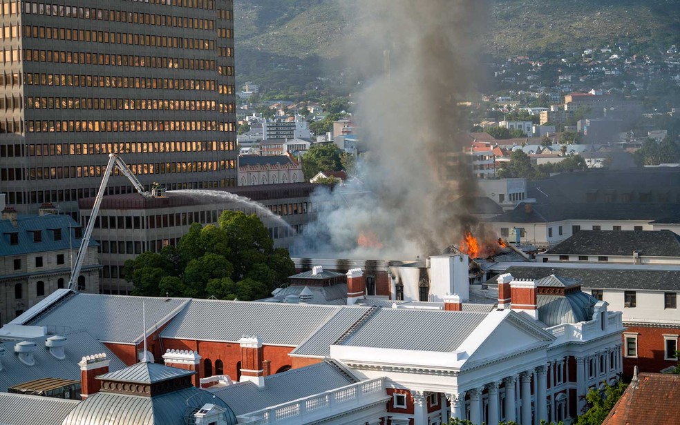 Bombeiros tentam controlar chamas no Parlamento da África do Sul — Foto: Jerome Delay / AP Photo