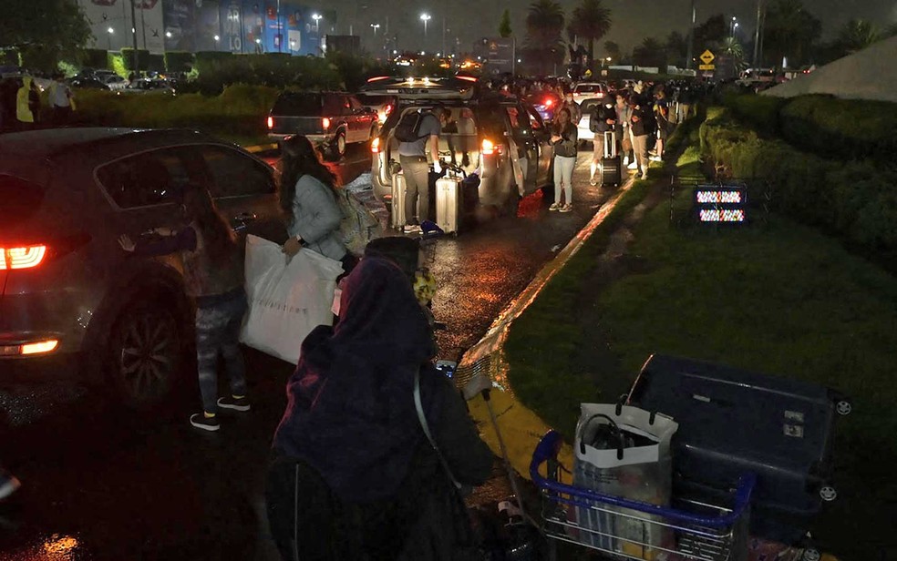 Passageiros do lado de fora do Aeroporto Internacional Benito Juarez, na Cidade do México, após tremor — Foto: Alfredo Estrella / AFP Photo