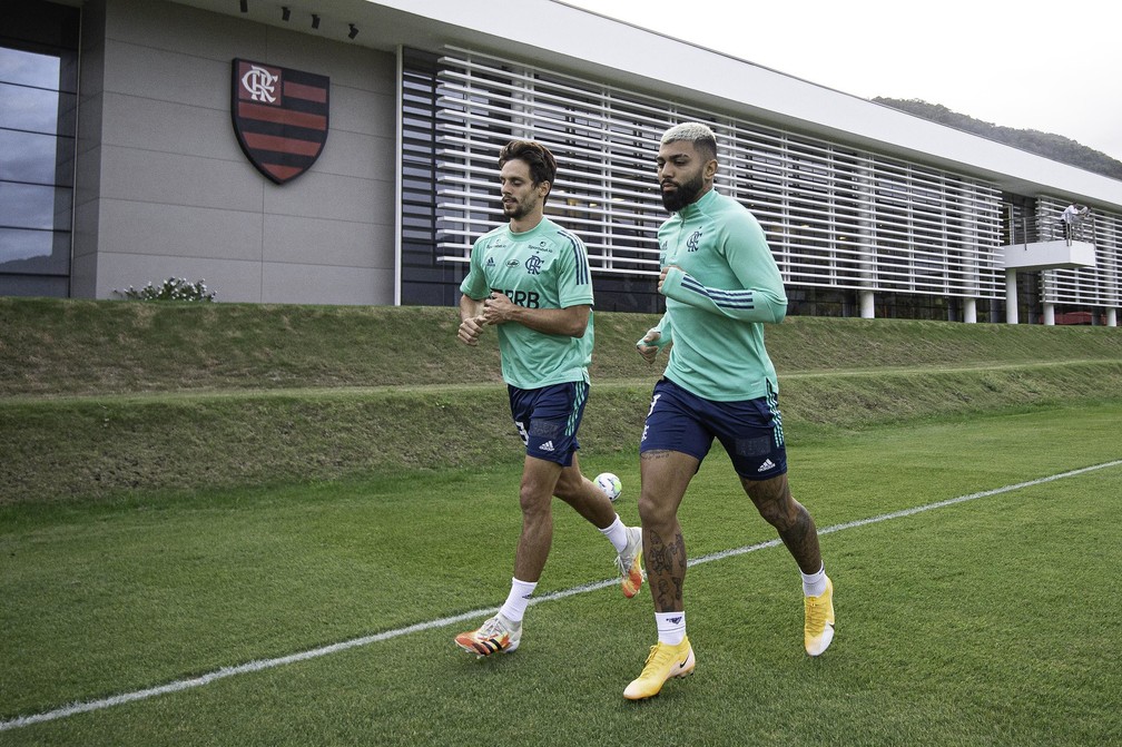 Rodrigo Caio e Gabigol correm no gramado do Ninho do Urubu — Foto: Alexandre Vidal / Flamengo