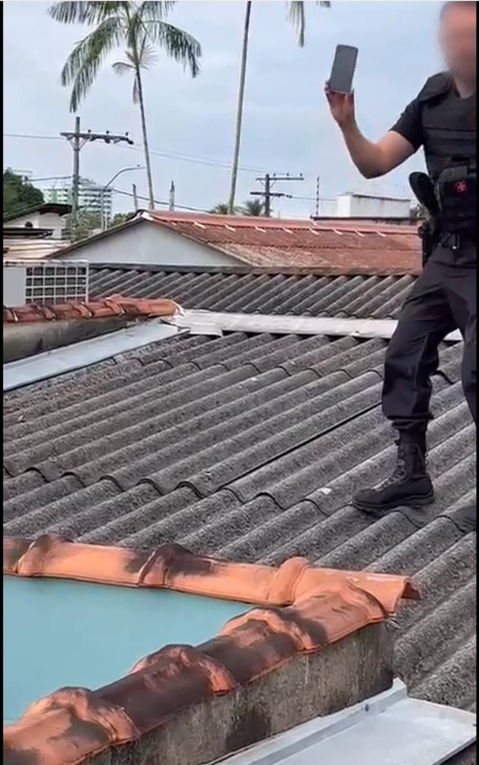 Policial federal recolheu celular em cima do telhado da casa de um dos investigados — Foto: Reprodução