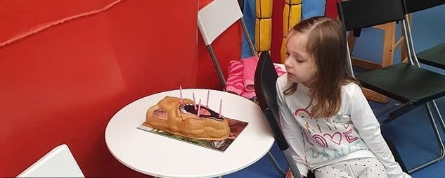 Remi observando seu bolo de aniversário (Foto: Reprodução Facebook)