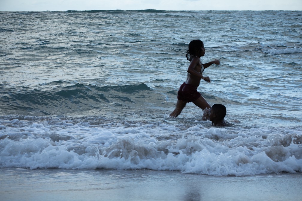 Ao entardecer, crianças brincam na praia central de Porto de Galinhas — Foto: Celso Tavares/G1