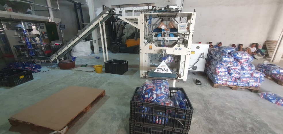 Máquinario, caixas de sabão OMO e embalagens do sabão da marca Brilhante foram localizadas na fábrica clandestina — Foto: PM/Divulgação
