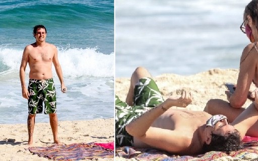 De máscara, Felipe Dylon toma sol em praia carioca