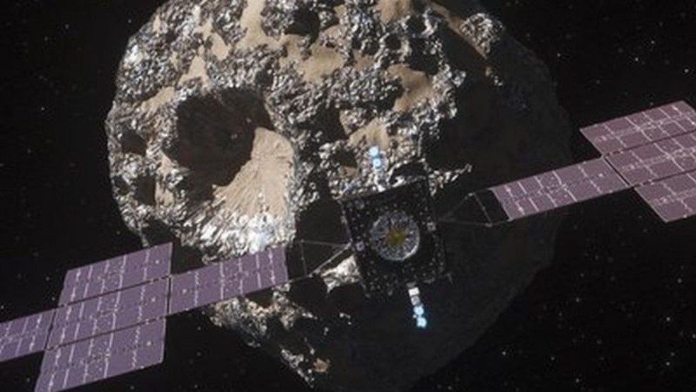 Impresso artstica da sonda Psyche da Nasa se aproximando do asteroide 16 Psych — Foto: NASA via BBC