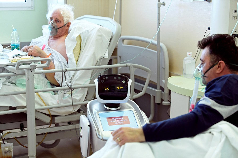 1º de abril - Paciente interage com um robô usado para monitoração em ala de infectados pelo novo coronavírus no hospital Circolo em Varese, na Itália — Foto: Flavio Lo Scalzo/Reuters