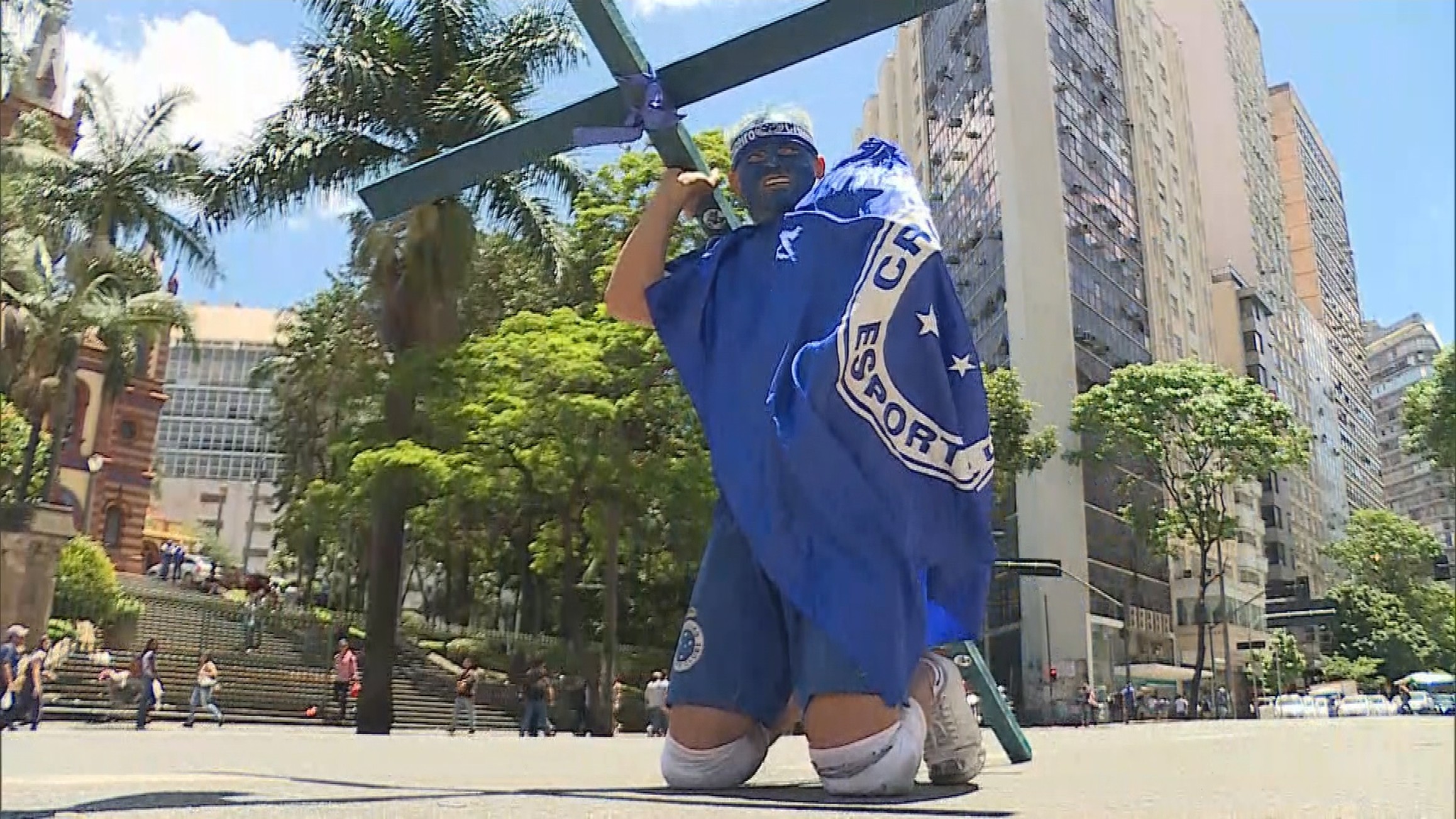 Torcedor do Cruzeiro paga promessa de joelhos pelas ruas de BH e tenta entregar cruz a Kalil