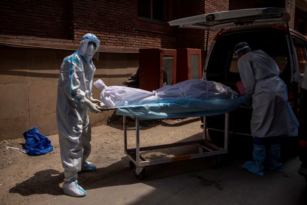 Corpo de homem que morreu de Covid-19 é colocado em ambulância em meio à pandemia do novo coronavírus em Nova Délhi, na Índia, nesta quinta-feira (15) — Foto: Danish Siddiqui/Reuters