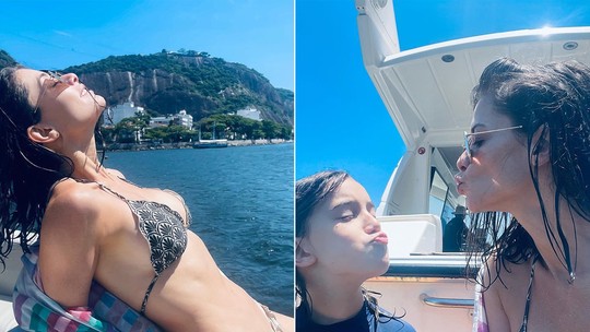 Alinne Moraes faz poses e dá chamego no filho em passeio de barco