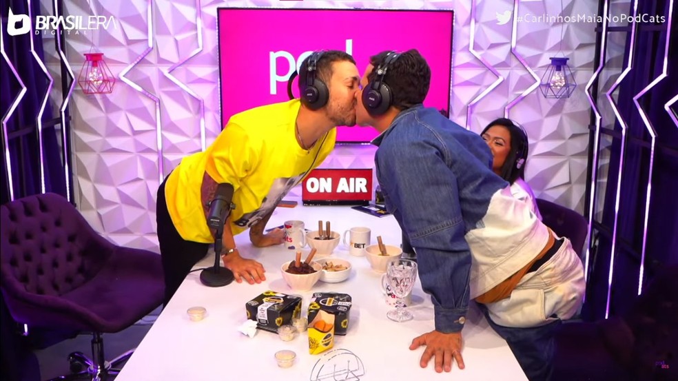 Carlinhos Maia e Lucas Guimarães dão selinho durante episódio de podcast — Foto: Reprodução/YouTube