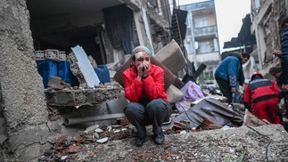 An earthquake survivor reacts as rescuers look for victims and other survivors in Hatay, the day after a 7.8-magnitude earthquake struck the country's southeast on February 7, 2023. - Rescuers in Turkey and Syria braved frigid weather, aftershocks and collapsing buildings, as they dug for survivors buried by an earthquake that killed more than 5,000 people. Up to 23 million people could be affected by the massive earthquake that has killed thousands in Turkey and Syria, the WHO warned on Tuesday, promising long-term assistance. — Foto: BULENT KILIC / AFP
