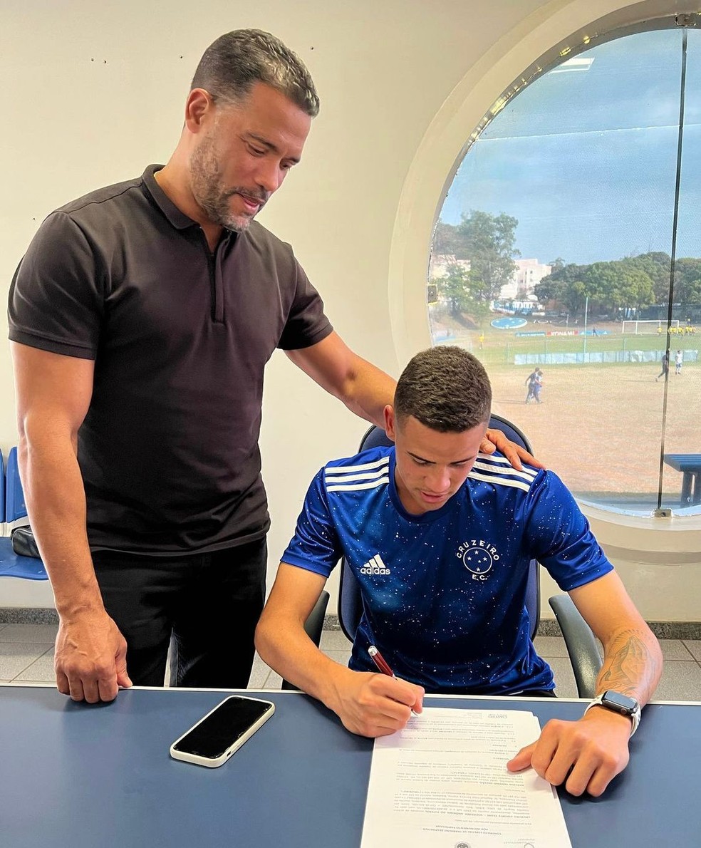 Arielson assinando contrato profissional com o Cruzeiro junto com Ângelo Canuto, empresário do atleta junto com Paulinho Nascimento  (Foto: Arquivo Pessoal)