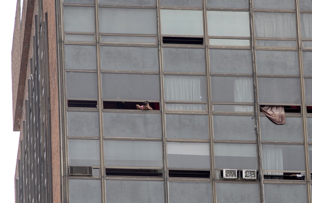 Mulher aguarda resgate durante incêndio em hotel no centro de Buenos Aires, Argentina — Foto: Damian Dopacio / NOTICIAS ARGENTINAS / AFP