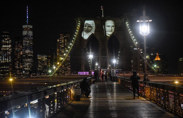 NEW YORK, NY - MARCH 14: Images of New Yorkers lost to the COVID-19 pandemic are projected on to the Brooklyn Bridge on March 14, 2021 in New York City. New York City honors lives lost to COVID-19 on the anniversary of the one year anniversary of the COVI (Foto: Getty Images)