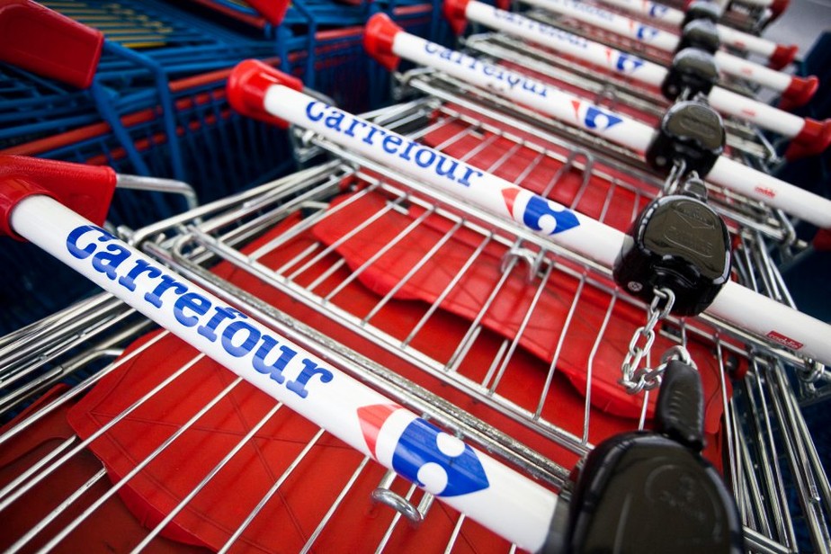 Carrefour- Branded shopping carts sit ready for use at a Carrefour SA hypermarket in Drancy, France, on Saturday, March 3, 2012. Carrefour SA, Tesco's largest European competitor, lowered its profit forecast twice in three months last year and in January