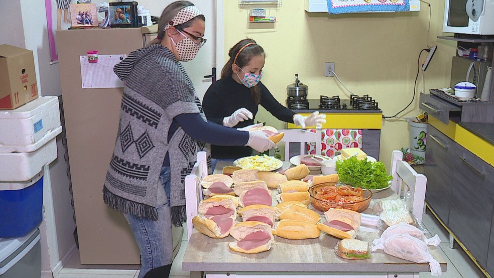 Thayla e a mãe na produção dos sanduíches em Sapiranga  — Foto: Reprodução/RBS TV