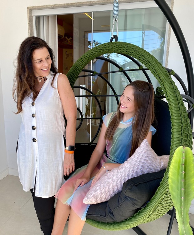 A atriz Clara Galinaria e a arquiteta Virna Carvalho posam na varanda do quarto, com balanço em corda naútica verde da CF Home Design (Foto: Michelle Garcia / Divulgação)