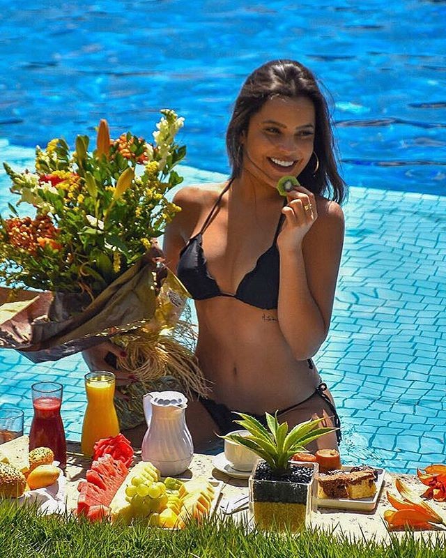 Emilly Araújo posa de biquíni na piscina com um buquê de flores Revista Marie Claire