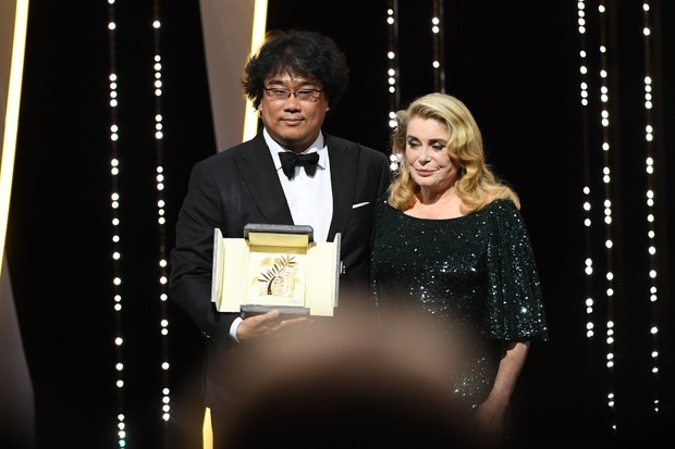 CANNES, FRANCE - MAY 25: Director Bong Joon-Ho with the Palme d'Or award for "Parasite" and Catherine Deneuve on stage during the Closing Ceremony of the 72nd annual Cannes Film Festival on May 25, 2019 in Cannes, France. (Photo by Gareth Cattermole/Getty (Foto: Getty Images)