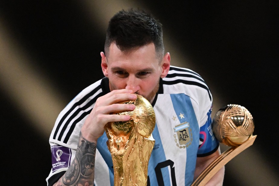 Argentina's captain and forward #10 Lionel Messi kisses the FIFA World Cup Trophy during the trophy ceremony after Argentina won the Qatar 2022 World Cup final football match between Argentina and France at Lusail Stadium in Lusail, north of Doha on December 18, 2022