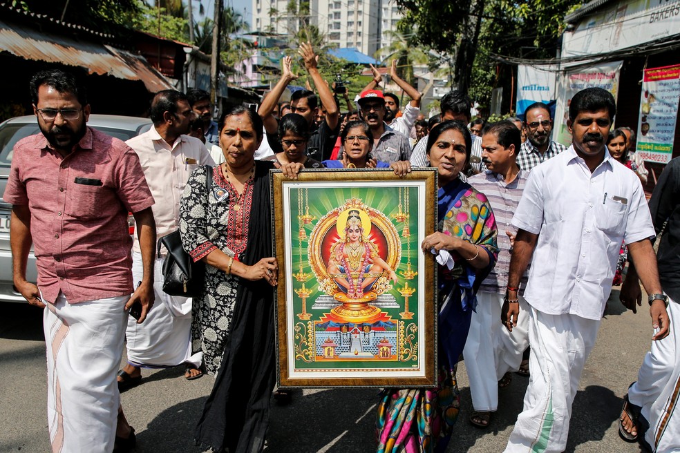Manifestantes carregam imagem da divindade hindu “Ayappa” em protesto convocado por várias organizações hindus após duas mulheres visitarem o tempo Sabarimala — Foto: Sivaram V/Reuters