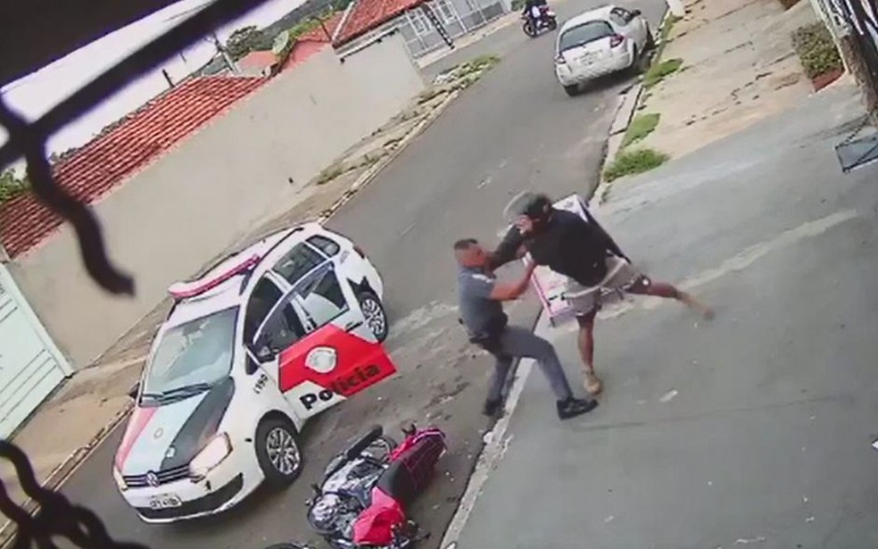 Policial dá socos e chutes no rapaz durante a abordagem em Agudos — Foto: Circuito de segurança/ Reprodução