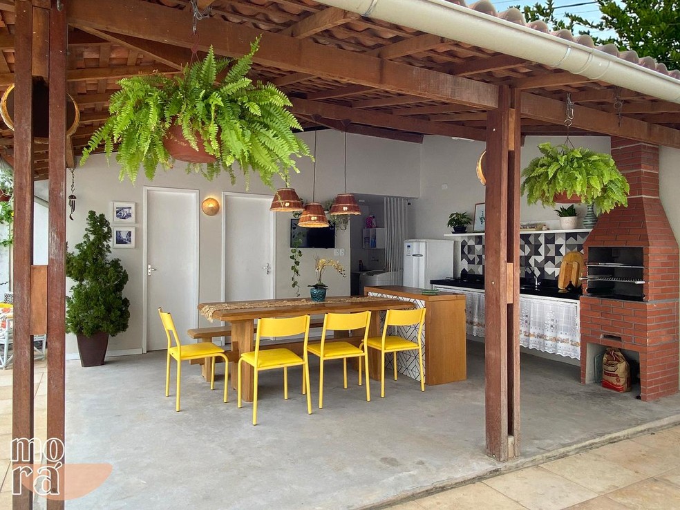 Área de churrasqueira com artesanato local em arandelas e pendentes (feitos com palhas), além do uso de madeira certificada, na mesa e na bancada.  — Foto: Arquivo Pessoal