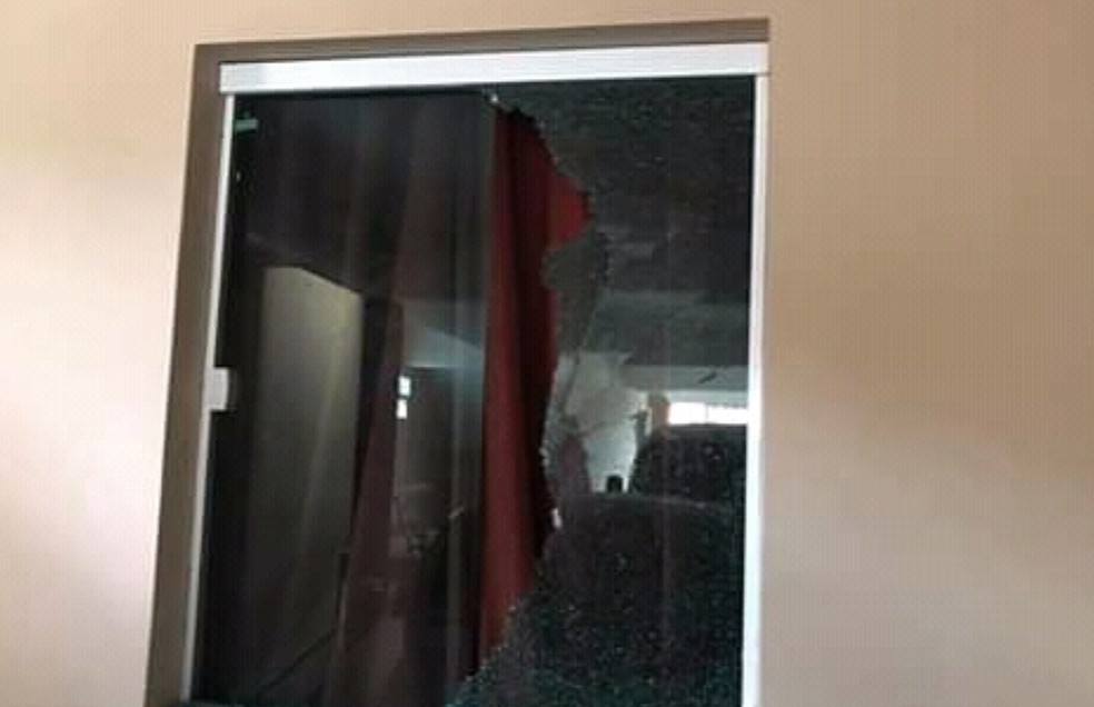 Janela foi atingida por tiros disparados pelos criminosos. — Foto: Reprodução/TV Verdes Mares