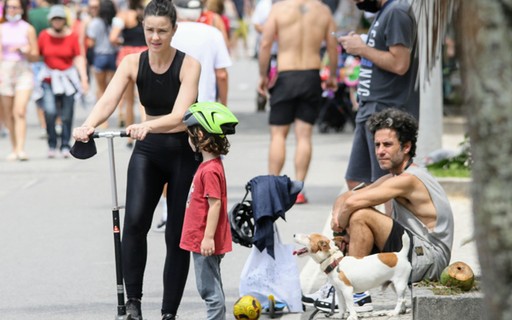 Carolina Kasting anda de patinete com o filho em orla no Rio