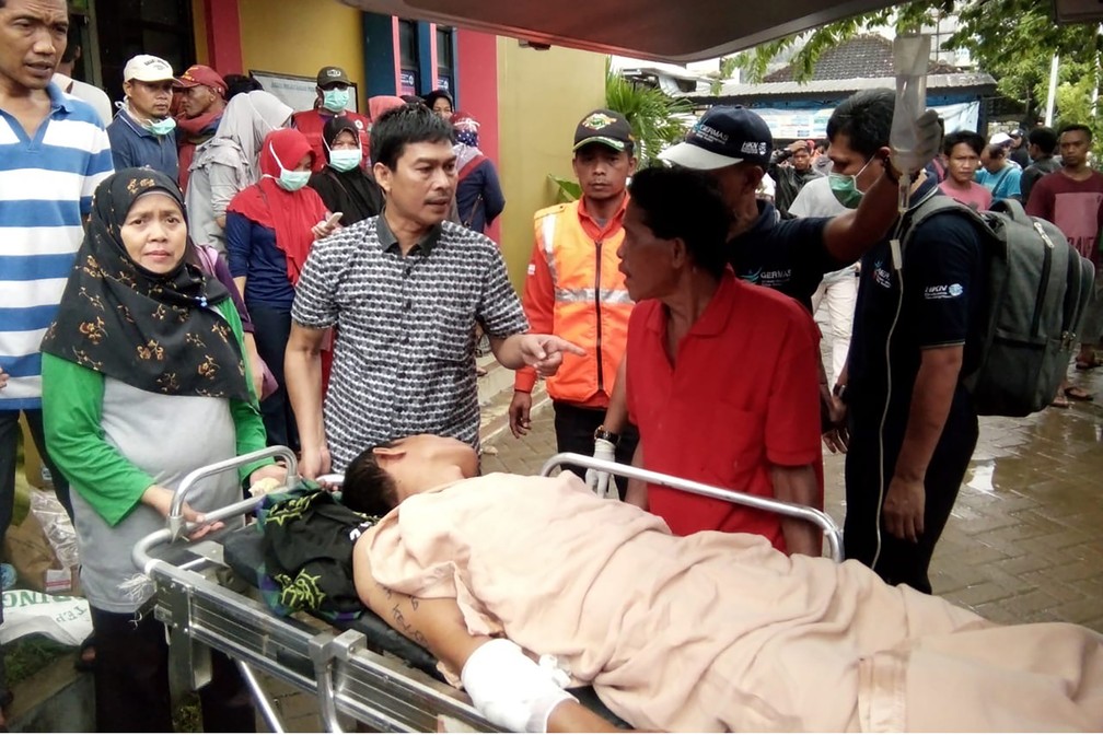 Vítimas de tsunami são atendidas em hospital de Carita, região atingida pelas ondas gigantes, na noite deste sábado (22), na Indonésia — Foto: Semi / AFP