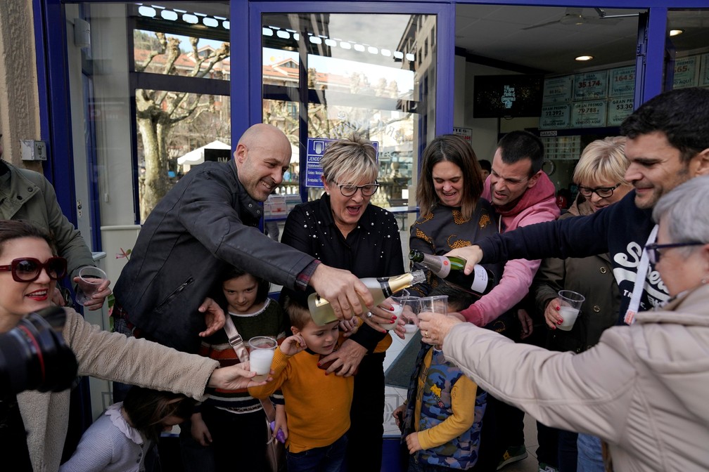 Público comemora sorteio de Natal da loteria espanhola neste sábado (22) em Guernica — Foto: Vincent West/Reuters