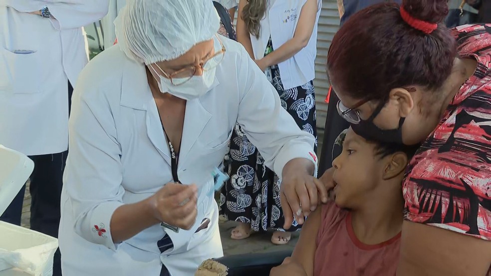 Carlos foi a primeira criança a receber a vacina contra Covid-19, no DF — Foto: Reprodução/TV Globo