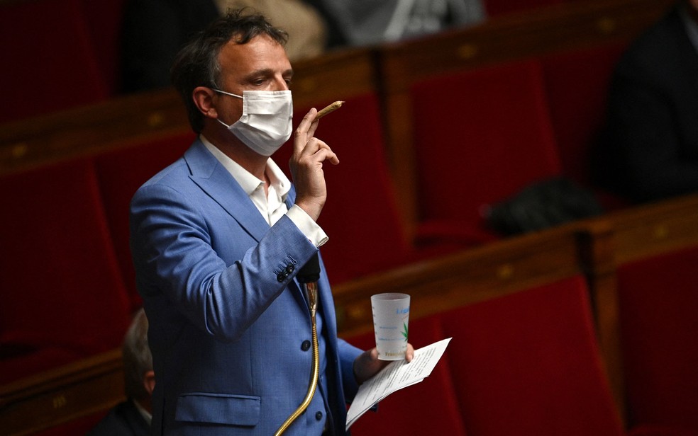 O deputado François-Michel Lambert exibe um baseado no parlamento francês para pedir a legalização da maconha, na terça-feira (4) — Foto: Christophe Archambault/AFP 