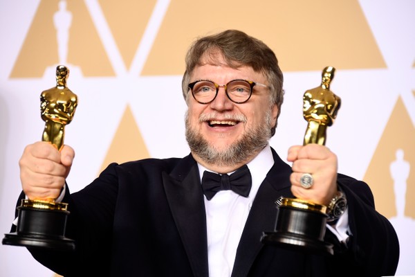 O cineasta Guillermo Del Toro com as estatuetas de Melhor Filme e Melhor Diretor vencidas por ele no Oscar 2018 por A Forma da Água (Foto: Getty Images)
