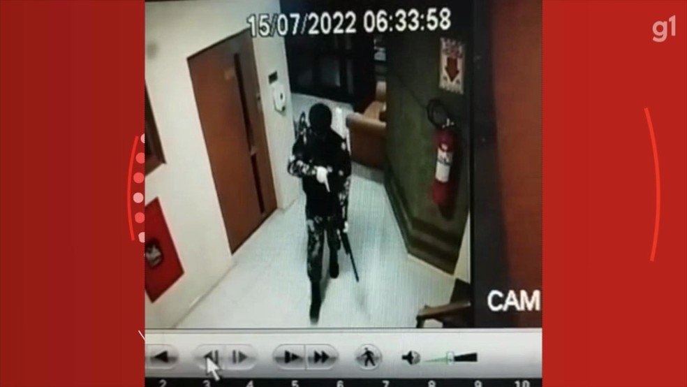 Câmeras de segurança do prédio mostram homens camuflados e com toucas ninja carregando fuzis — Foto: Reprodução