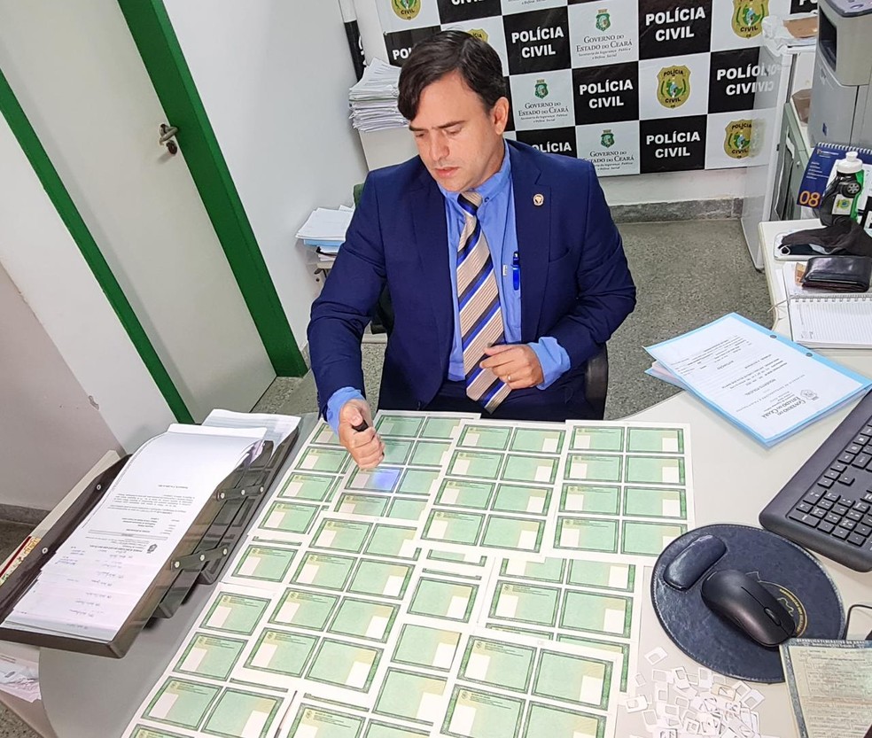 Delegado Carlos Teófilo usou luz ultravioleta em espelhos de documentos apreendidos em Fortaleza. — Foto: Rafaela Duarte/ SVM