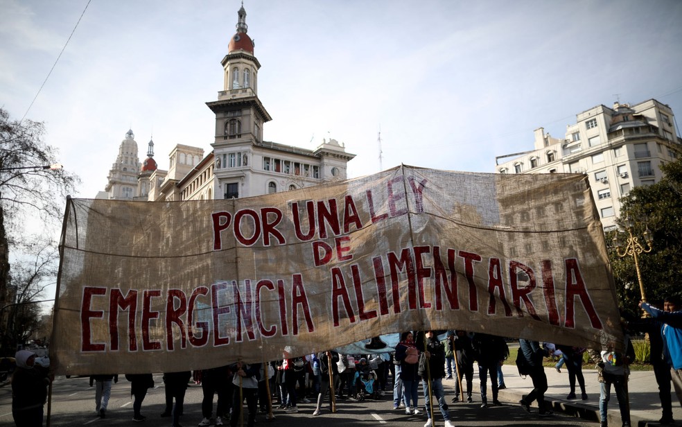 Manifestantes exibem faixa pedindo emergência alimentar em frente ao Congresso, em Buenos Aires, na Argentina, no dia 4 de setembro — Foto: AP Photo/Natacha Pisarenko