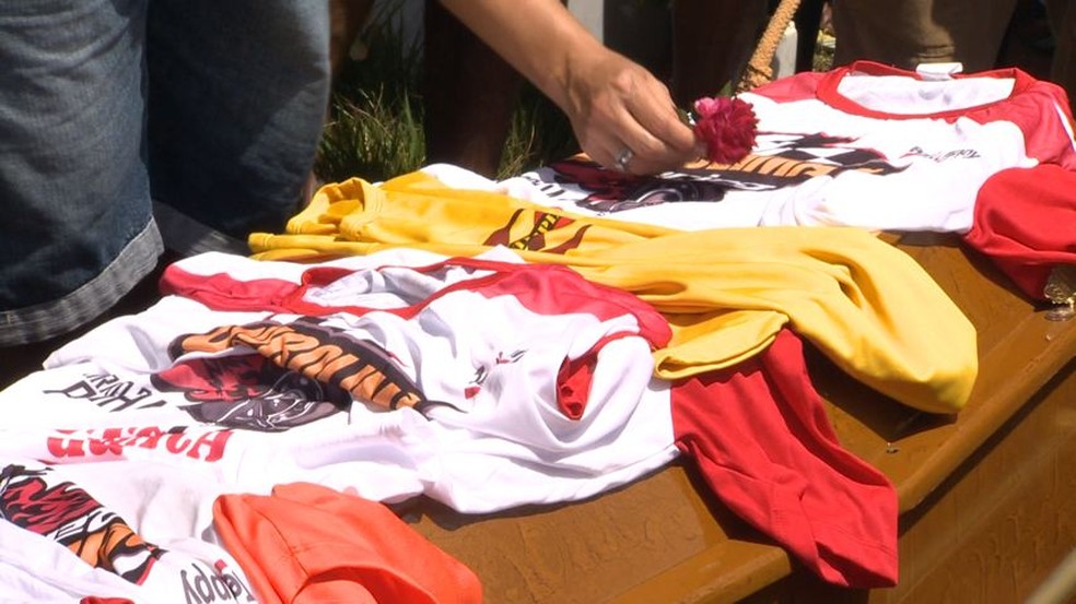 Camisas da tradicional Corrida de Carrinhos de Rolimã do Bairro da Penha foram colocadas em cima do caixão — Foto: Manoel Neto/TV Gazeta
