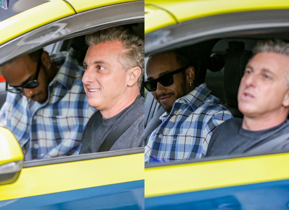 Lewis Hamilton desembarca no aeroporto Santos Dumont e sai de táxi com Luciano Huck