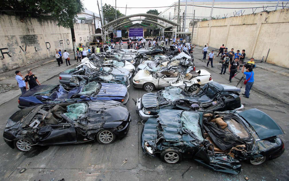 Carros de luxo contrabandeados apreendidos em Manila, nas Filipinas, após serem destruídos por escavadeira, na terça-feira (6) (Foto: Reuters/Romeo Ranoco)