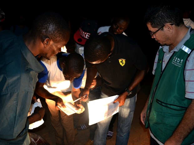 Equipe da Secretaria de Desenvolvimento Social do Acre (SEDS) confere lista de embarque dos imigrantes (Foto: Yuri Marcel/G1)