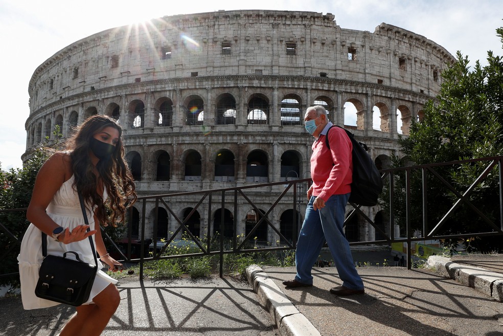 Pessoas vestem máscara em frente ao Coliseu de Roma, em 13 de outubro. País reforçou medidas de restrição para a Covid-19 — Foto: Guglielmo Mangiapane/Reuters