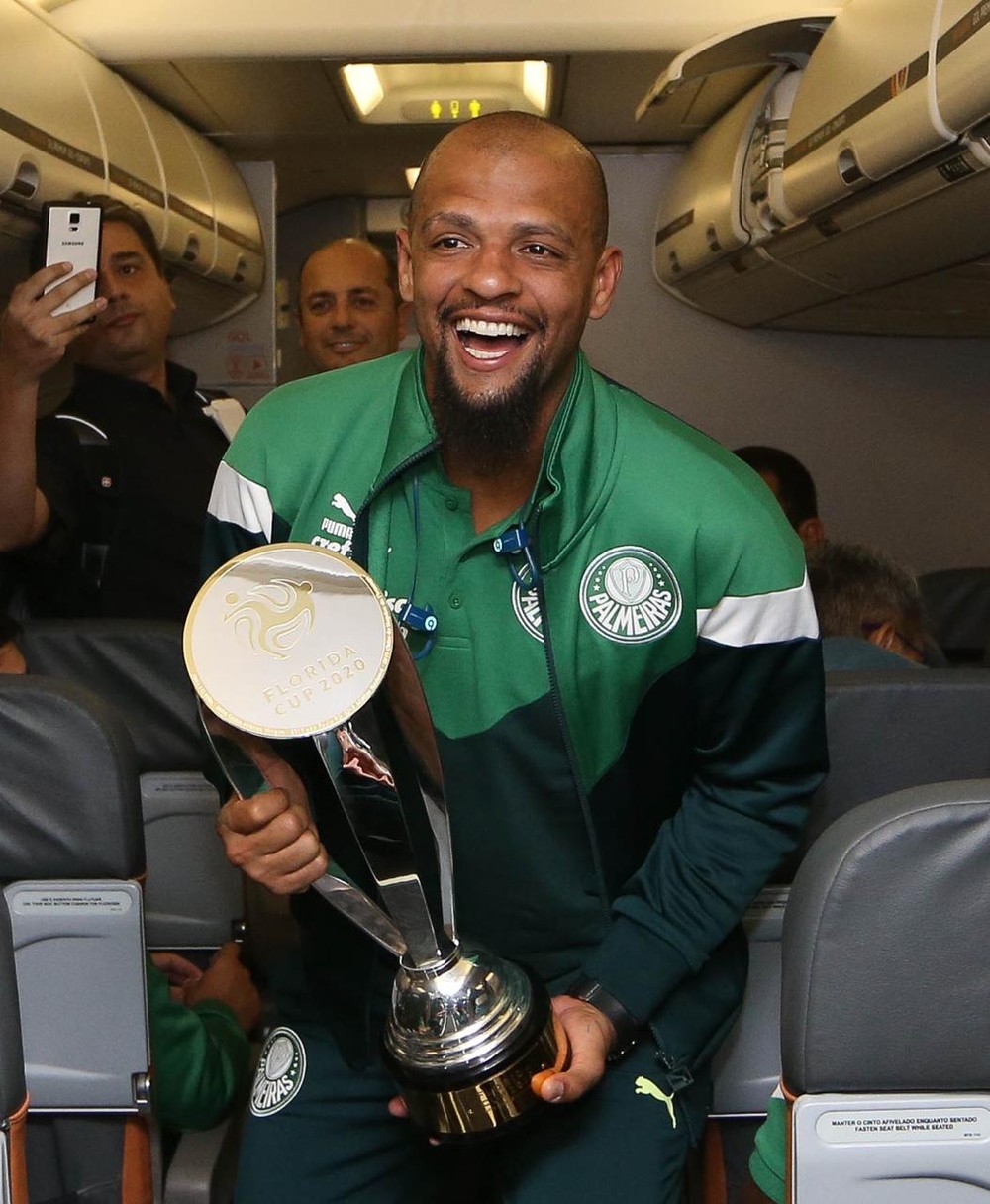 Felipe Melo, capitão do Palmeiras, ergue taça do Torneio da Flórida dentro do avião; fotos