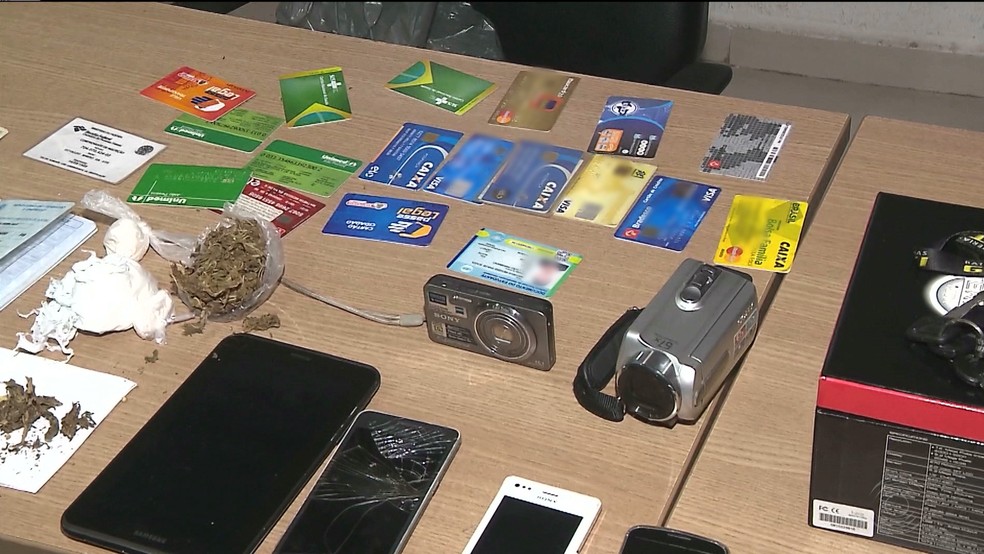 Na resid&ecirc;ncia, foram encontrados cart&otilde;es de cr&eacute;dito de v&aacute;rias pessoas diferentes, celulares, c&acirc;meras e drogas. (Foto: Reprodu&ccedil;&atilde;o/TV Cabo Branco)
