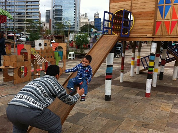 Pai e filho brincam em escorregador montado no Largo da Batata, em São Paulo (Foto: Paula Paiva Paulo)