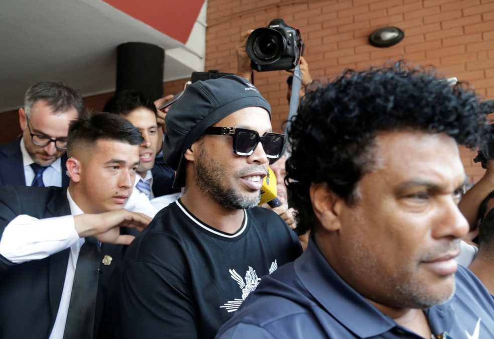Ronaldinho Gaúcho e Assis saem do depoimento no Paraguai — Foto: REUTERS/Jorge Adorno