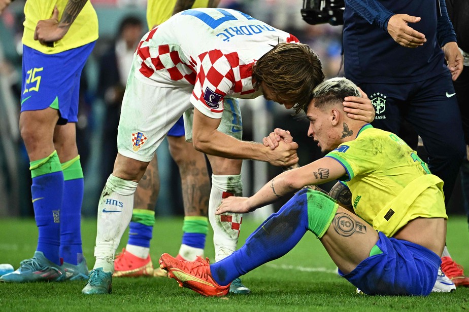 Croatia's midfielder #10 Luka Modric comforts Brazil's forward #19 Antony after qualifying to the next round after defeating Brazil in the penalty shoot-out of the Qatar 2022 World Cup quarter-final football match between Croatia and Brazil at Education City Stadium in Al-Rayyan, west of Doha, on December 9, 2022