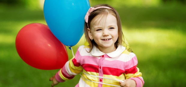 Criança segurando balões de aniversário  (Foto: Shutterstock)