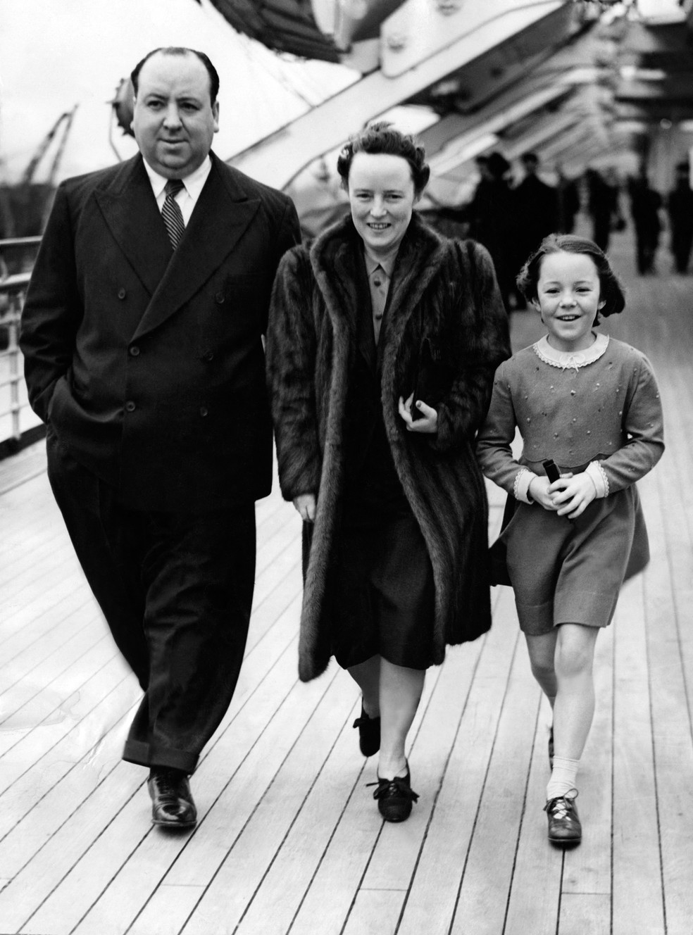 Diretor britânico Alfred Hitchcock caminha com a mulher Alma Reville e a filha Patricia Hitchcock à bordo do navio The Queen Mary em março de 1939 — Foto:  AFP/Arquivo
