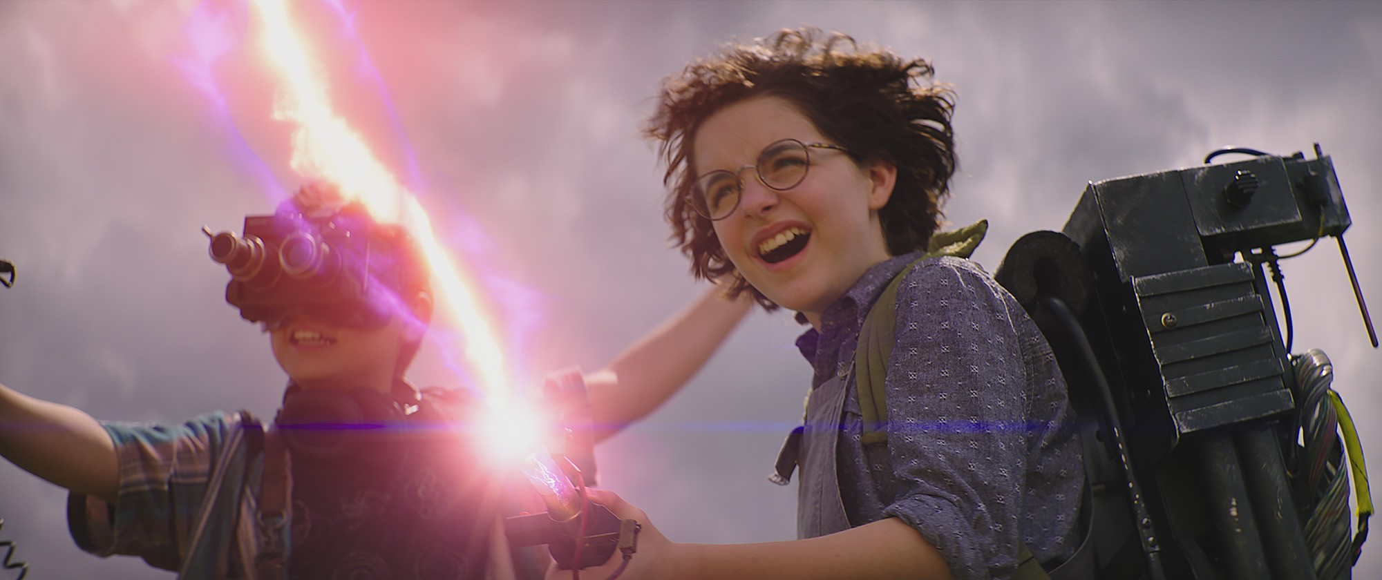Phoebe (Mckenna Grace) and Podcast (Logan Kim, left) fire a proton pack for the first time in Columbia Pictures' GHOSTBUSTERS: AFTERLIFE. (Foto: Divulgação)